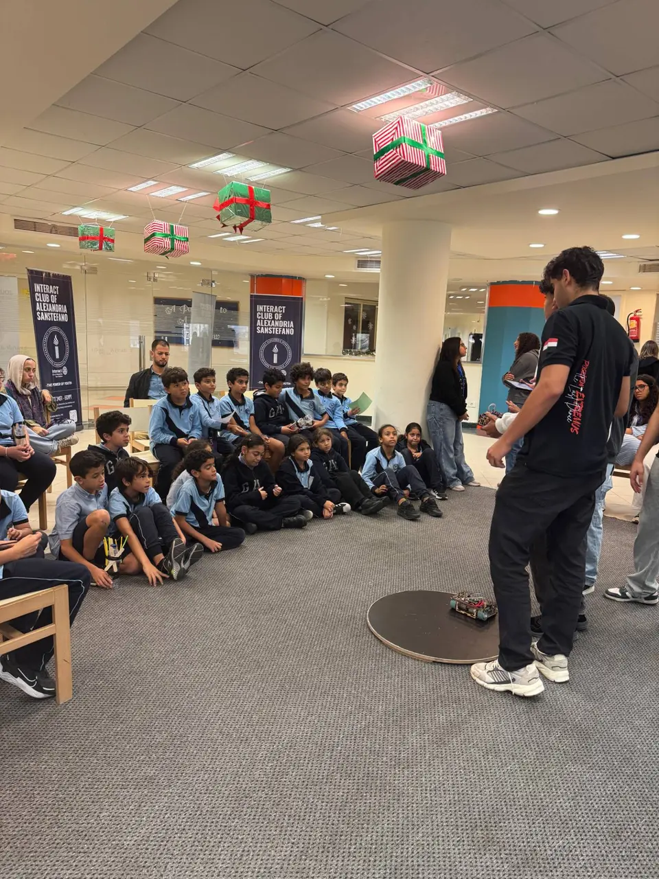 School students watching a robotics demo