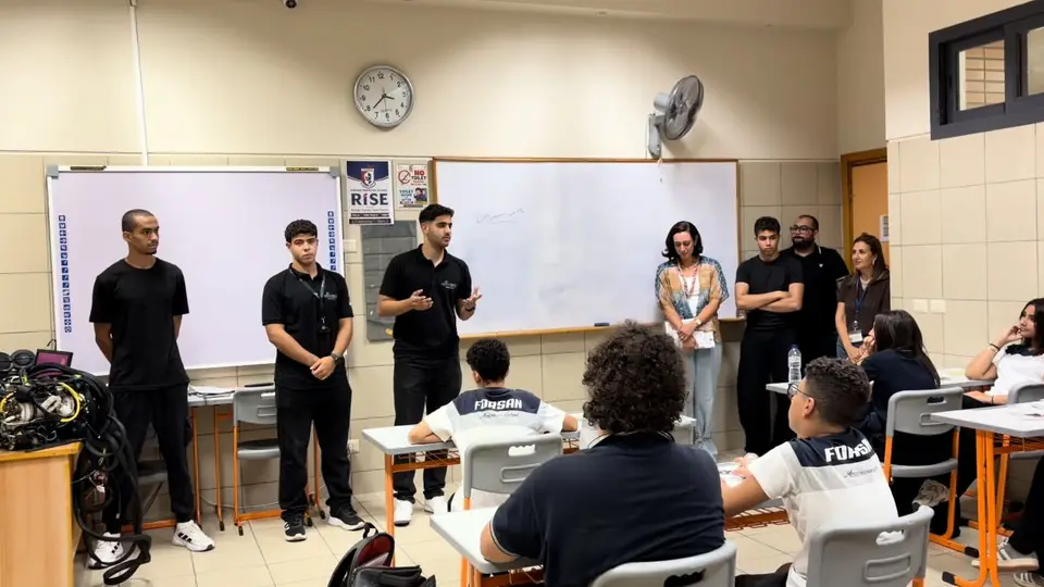 The team presenting to a class